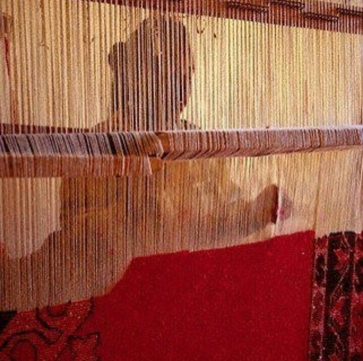 Knotting by master weavers at the wooden loom